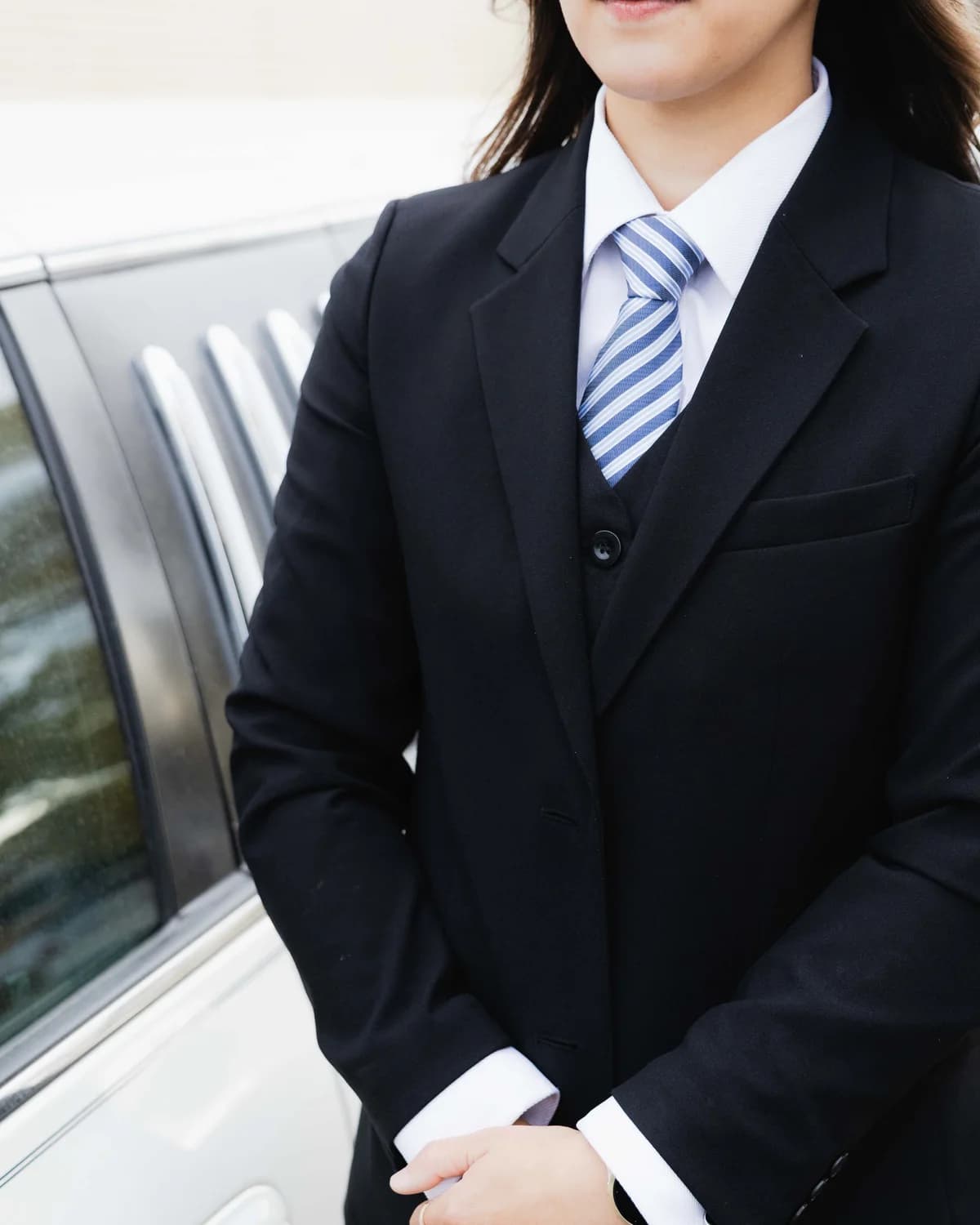 A Generations funeral director waiting beside the car before a service
